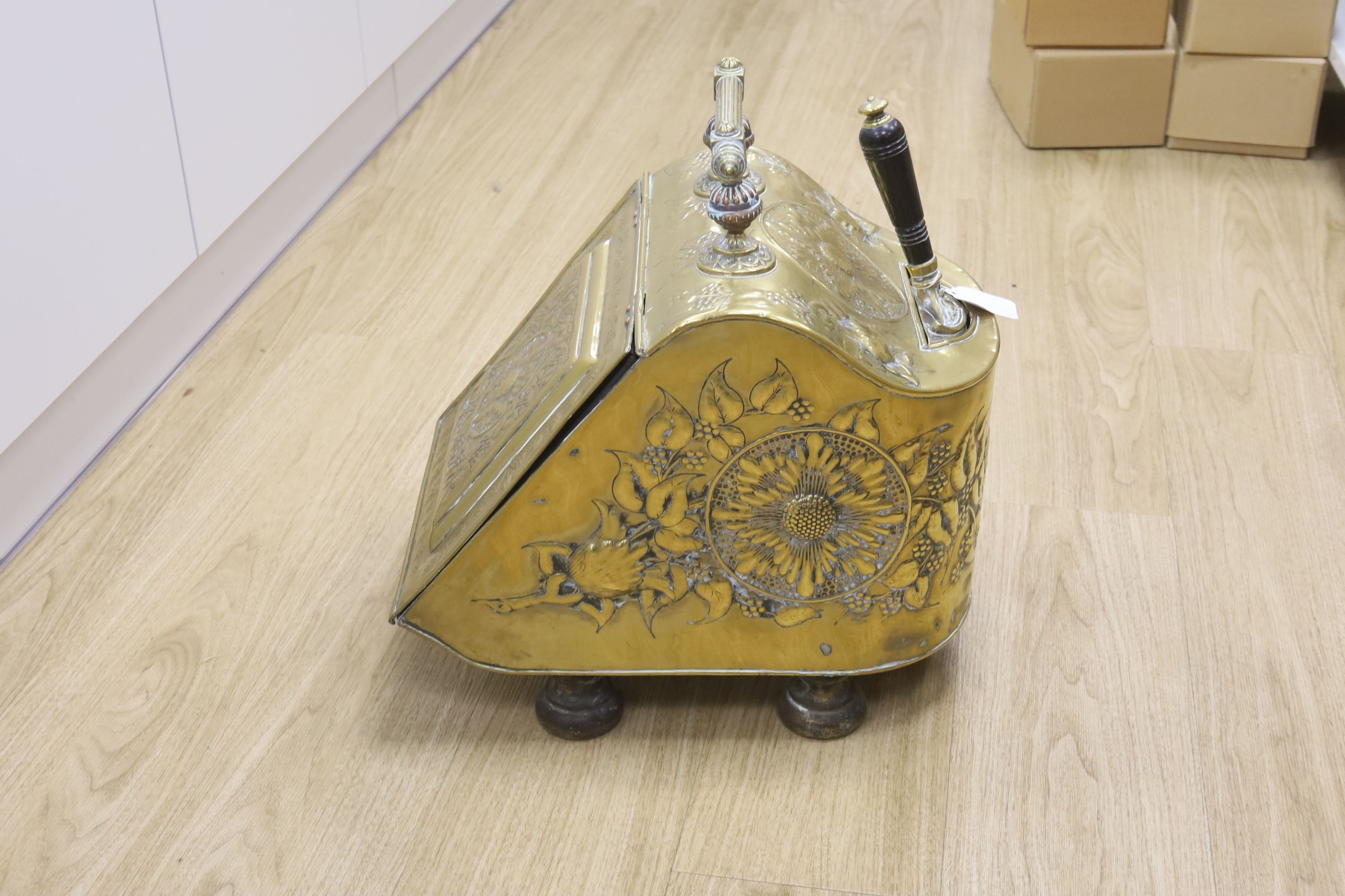 A Dutch embossed brass coal scuttle